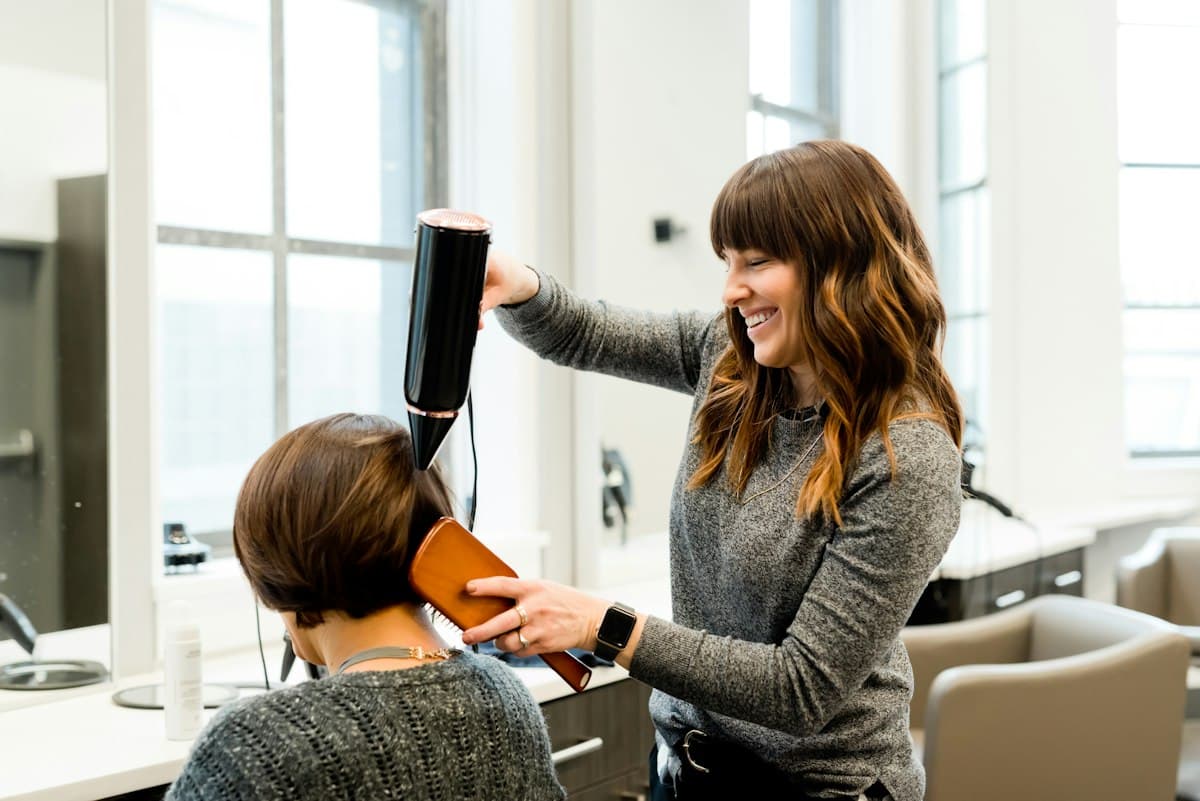 A stylist at work in a bright salon